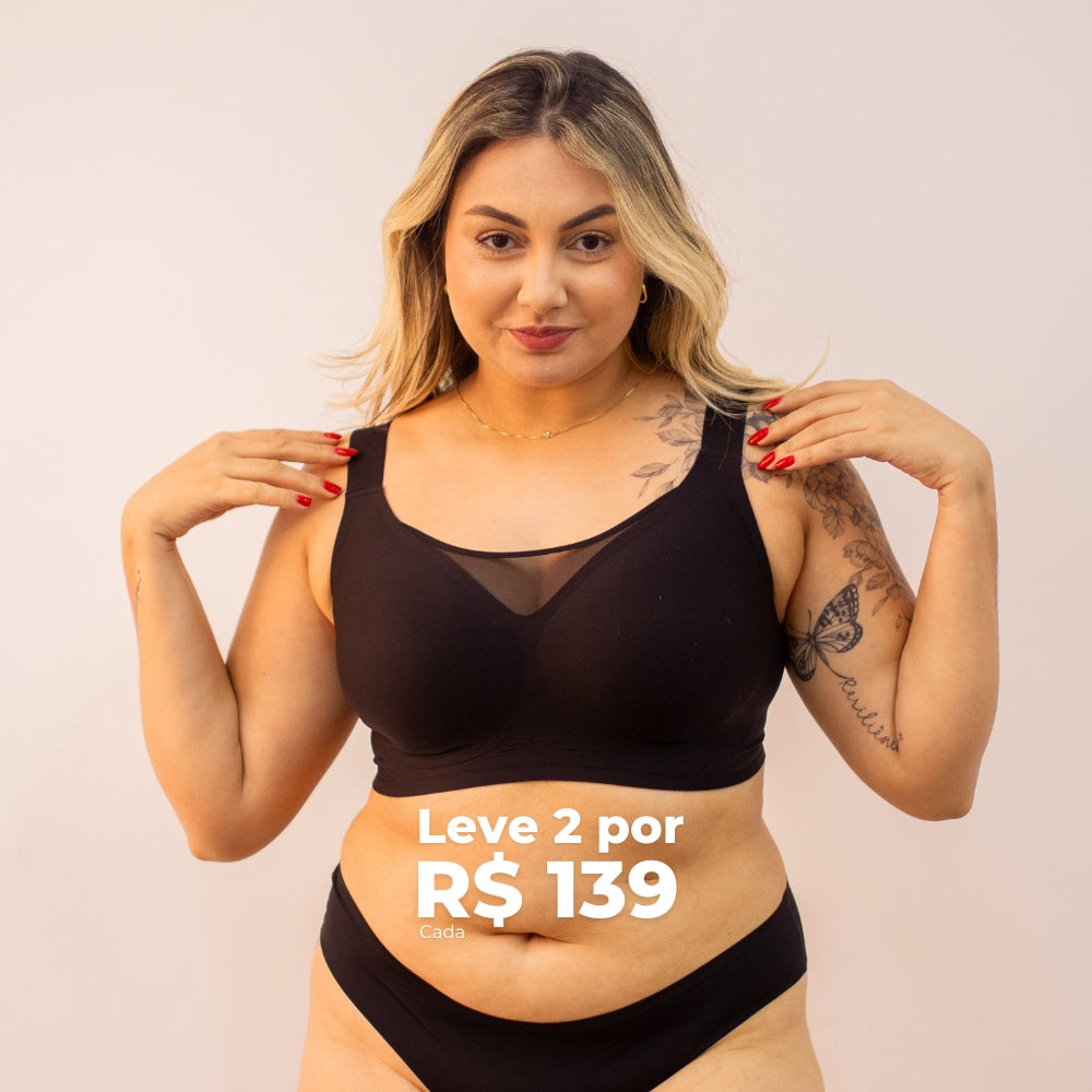Mulher confiante vestindo sutiã preto Cygnuss com modelagem anatômica e detalhe em tela no decote. Texto promocional destacando a oferta "Leve 2 por R$ 139