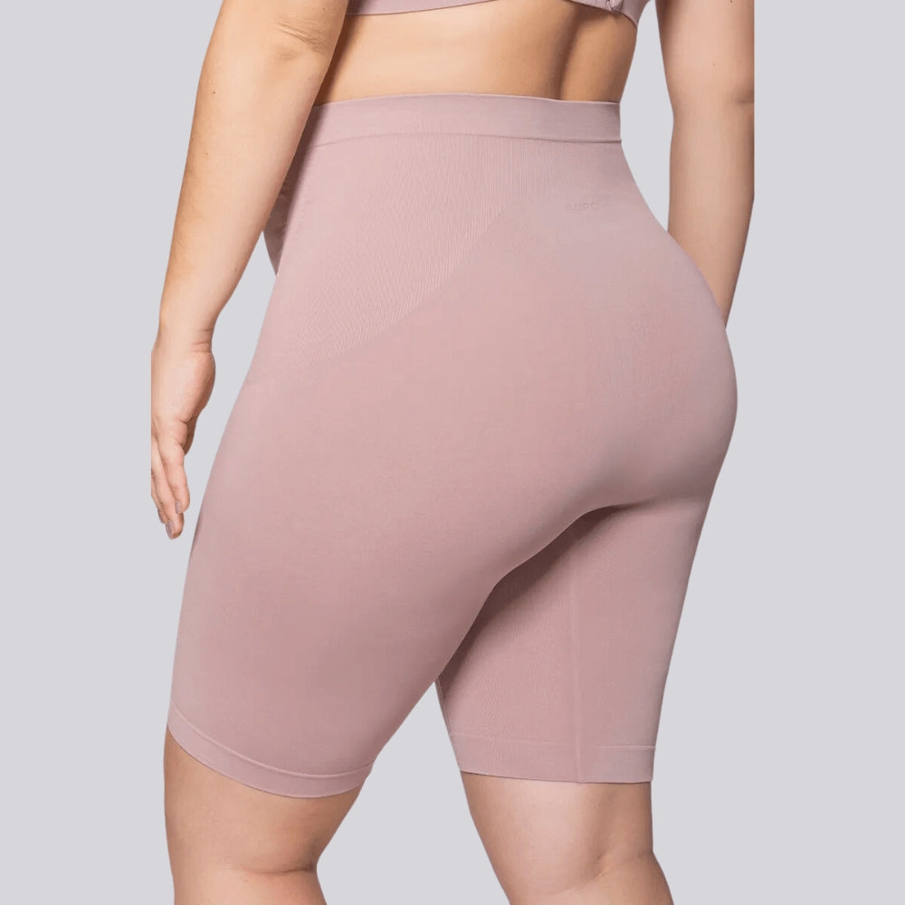 Vista traseira do Short Gestante Microfibra Cygnuss x Lupo na cor rosada, em modelo plus size, evidenciando o caimento confortável, a elasticidade do tecido e a modelagem anatômica.