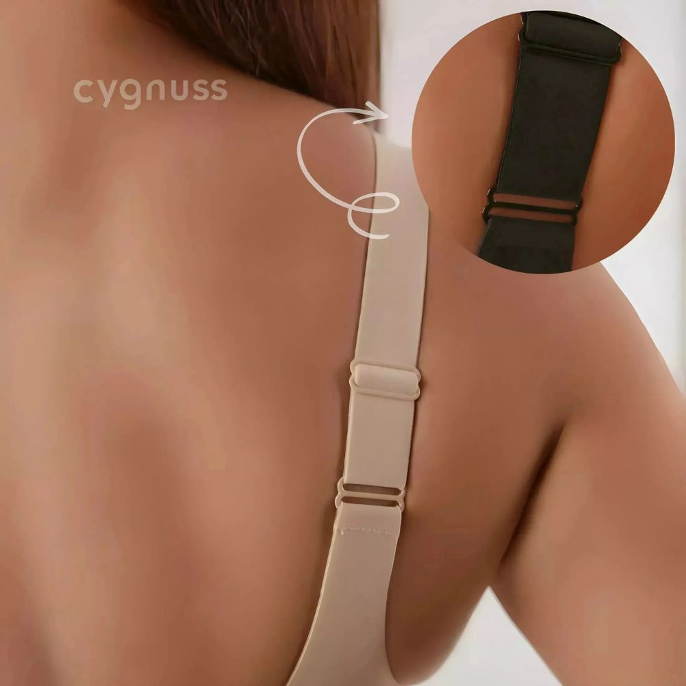 Close-up das costas de uma mulher vestindo o Sutiã Dreams na cor nude, destacando as alças largas e ajustáveis para melhor sustentação e conforto. A imagem também inclui um detalhe em destaque de uma versão preta do sutiã, mostrando o ajuste das alças. O logo da Cygnuss está visível no canto superior esquerdo.