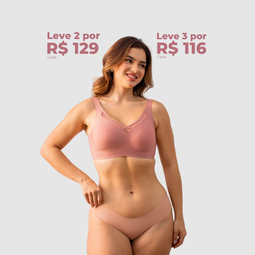 Mulher vestindo o Sutiã Dreams e uma calcinha nude da Cygnuss, sorrindo e posando contra um fundo cinza claro. Acima dela, há uma oferta promocional destacando os preços: "Leve 2 por R$ 129 cada" e "Leve 3 por R$ 116