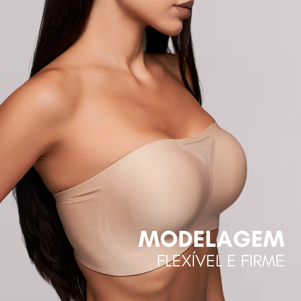 Modelo vestindo o Sutiã Tomara que Caia Sensação na cor bege. A peça apresenta um design sem alças, com detalhe em tule no decote, oferecendo modelagem flexível e firme. Texto promocional na imagem: "MODELAGEM FLEXÍVEL E FIRME"