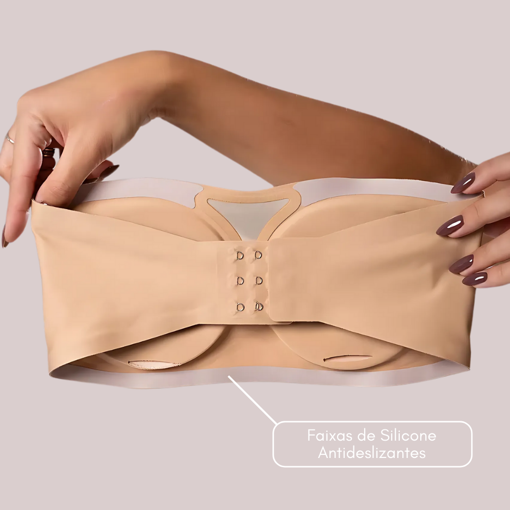 Imagem do Sutiã Tomara que Caia Sensação na cor bege, sendo segurado por duas mãos, destacando a parte traseira. A ilustração enfatiza as faixas de silicone antideslizantes na parte interna, garantindo aderência segura e ajuste firme sem deslizar.
