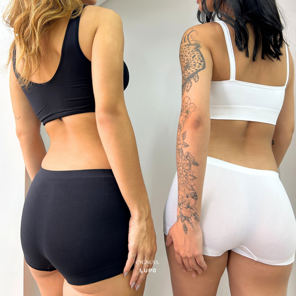 Duas mulheres vestindo Calcinha Boxer Essential preta e branca da Cygnuss x Lupo, exibindo conforto e ajuste anatômico.
