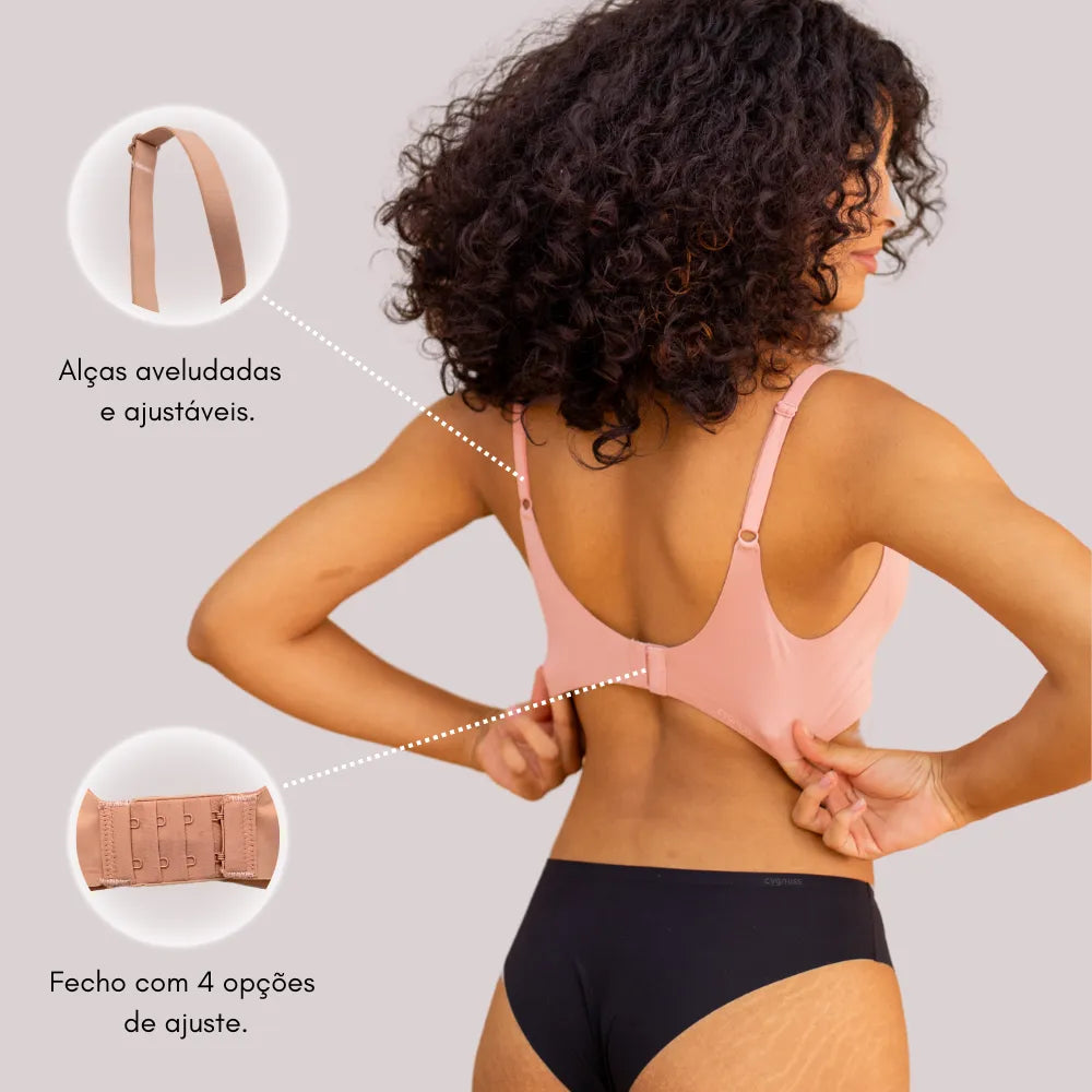 Mulher vestindo sutiã com alças ajustáveis e fechamento com 4 opções. Sutiã confortável, sem costura e invisível.